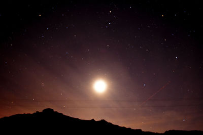 Low angle view of landscape against sky at night