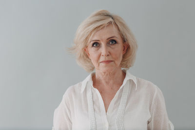 Portrait of woman against white background