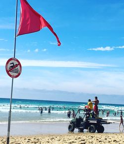 People on beach against sky