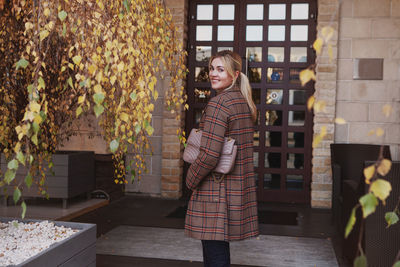 Portrait of stylish woman with beautiful smile, fashion trend of autumn clothes, checkered jacket. 