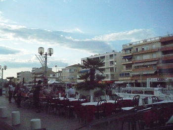 Street amidst buildings in city against sky