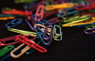 Close-up of colorful paper clips on table