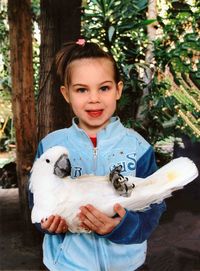 Portrait of girl holding bird