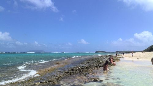 Scenic view of beach against blue sky