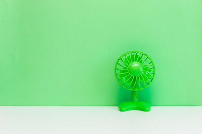 Close-up of green toy against blue background