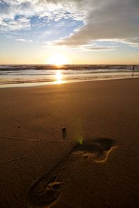 Scenic view of beach against sky during sunset
