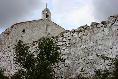 Low angle view of bell tower against sky