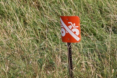 Close-up of road sign on field