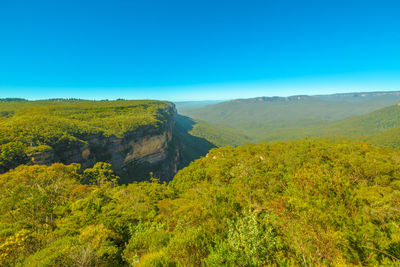 Scenic view of mountains against clear blue sky