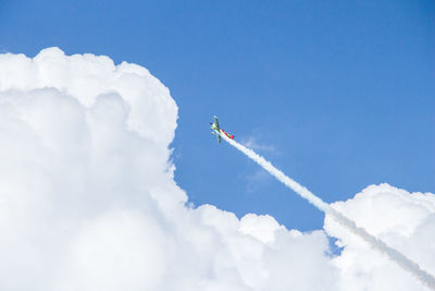 Low angle view of airplane flying against sky