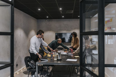 Multiracial male and female colleagues in board room at startup company