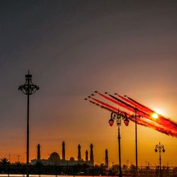 Low angle view of illuminated building at sunset