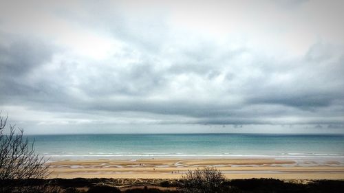 Scenic view of sea against cloudy sky