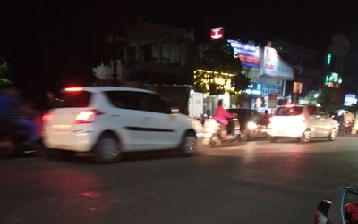 Cars on city street at night