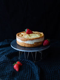 Classic polish cake karpatka with fresh strawberries on dark blue background