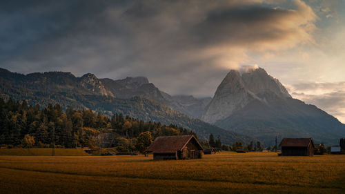 Scenic view of field and mountains against sky