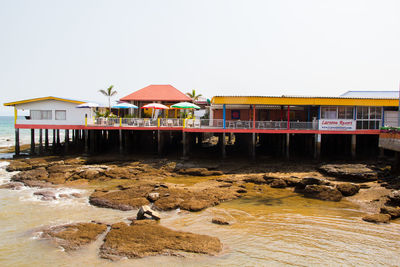 Built structure on beach against clear sky