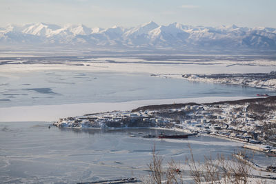 Scenic view of river and snowcapped mountains at avacha bay