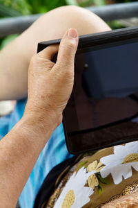 Midsection of person holding digital tablet
