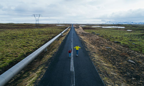 Road amidst land against sky