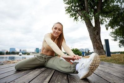 Portrait of smiling friends sitting on table