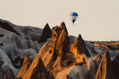 View of hot air balloon flying over rocks