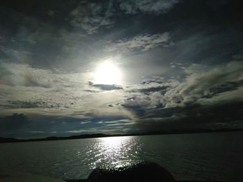 Scenic view of sea against bright sun