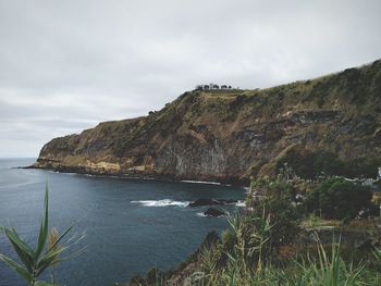 Scenic view of sea and mountains against sky