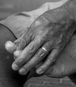 Midsection of couple holding hands