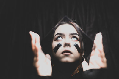 Portrait of young woman looking up