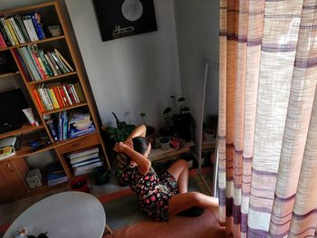 Woman reading book at home