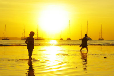 Silhouette people at beach during sunset in east nusa tenggara indonesia