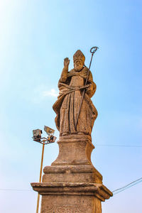 Low angle view of statue against blue sky