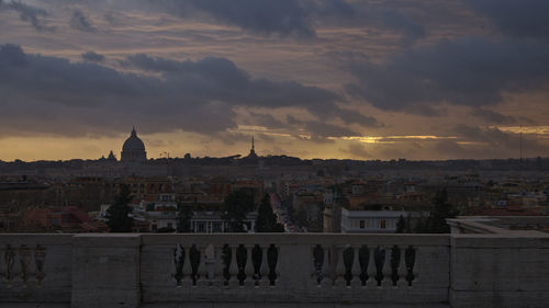 View of buildings in city at sunset