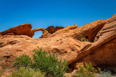 Rock formations against clear blue sky