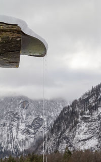 Close-up of rope hanging on mountain against sky