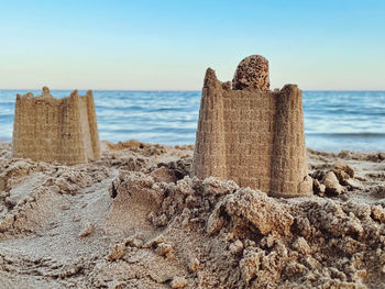 Scenic view of rocks on beach against sky