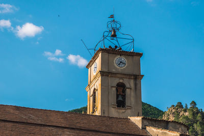 Low angle view of clock tower against sky