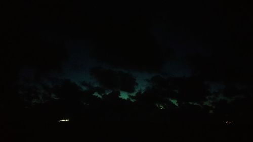 Low angle view of illuminated building against cloudy sky