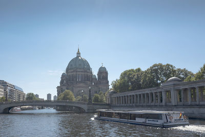 View of bridge over river against clear sky