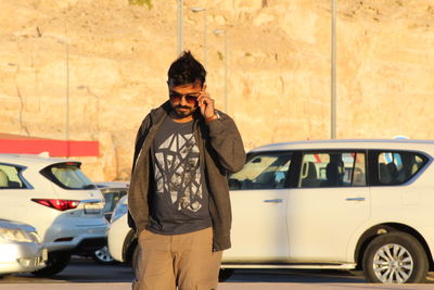 Full length of man standing in car