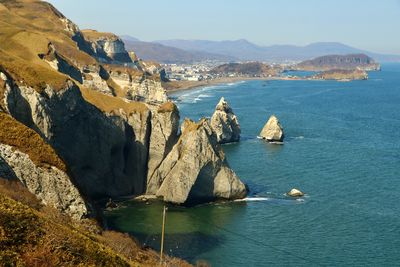 Scenic view of sea and mountains against sky