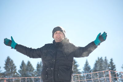 Full length of man standing on snow against sky