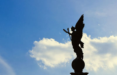 Low angle view of statue against blue sky