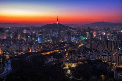 High angle view of city lit up at dusk