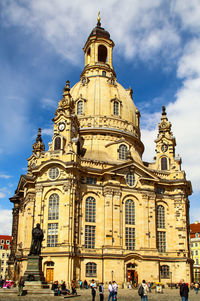 People walking in front of historic building