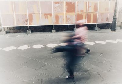 Blurred motion of man riding bicycle