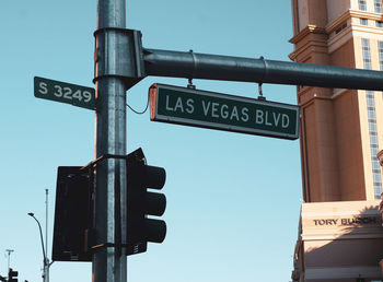 Low angle view of road sign against sky