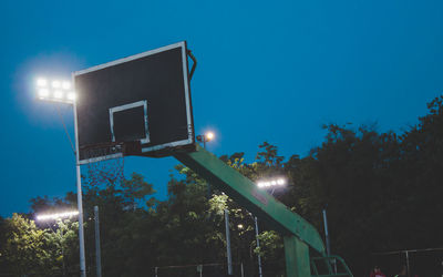 Low angle view of basketball hoop against blue sky