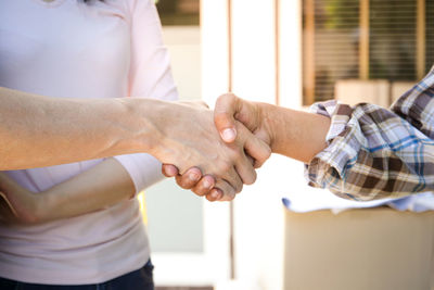 Midsection of man holding hands